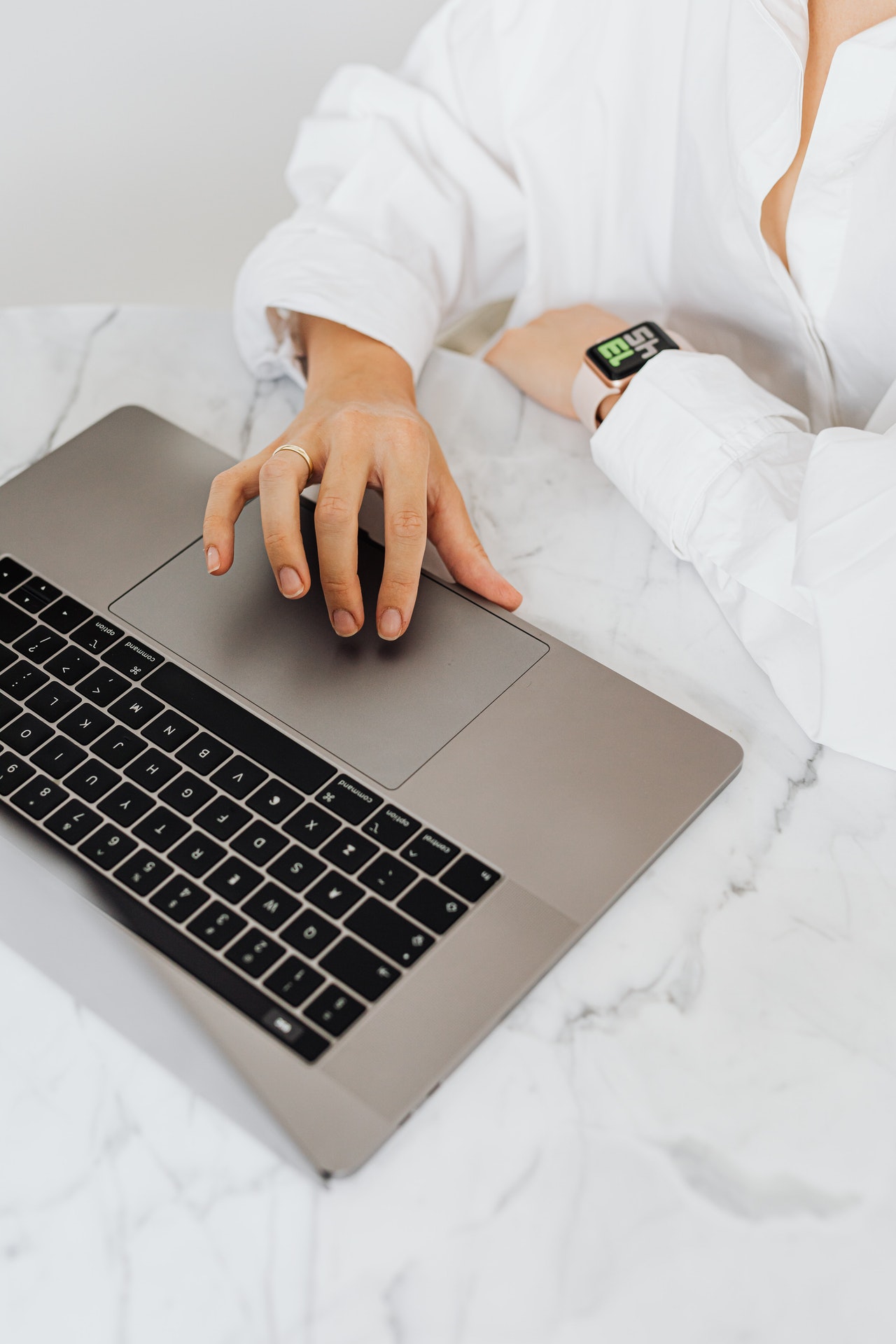 Frau sitzt mit Laptop an einem runden Tisch